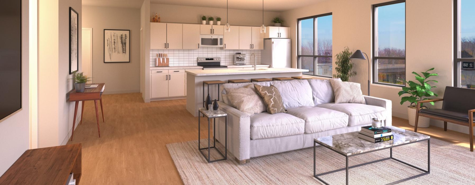 a living room with a couch and a table with a kitchen in view