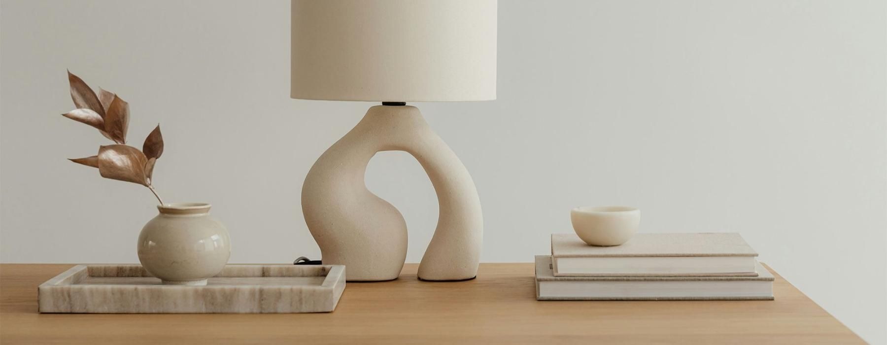 a lamp, stack of books, and decor