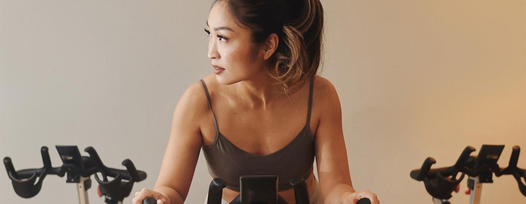 a woman riding a stationary bike